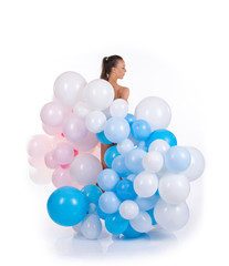 Nude girl with balloons posing on a white background.