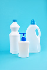 group of blank detergent product bottles over blue background. copy space. cleaning and washing equipment concept