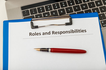 Roles and responsibilities paper document at the table