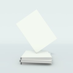 Stack of white hardback books isolated on light background.