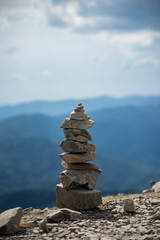 Fototapeta na wymiar Closeup of stone balance on mountain landscape background