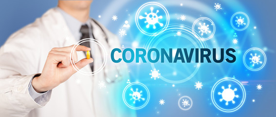 Doctor giving pill with CORONAVIRUS inscription, coronavirus concept