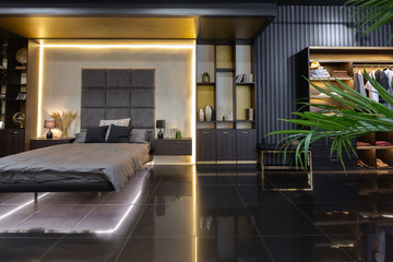 dark modern stylish male apartment interior with lighting, decorative walls, fireplace, dressing area and huge window