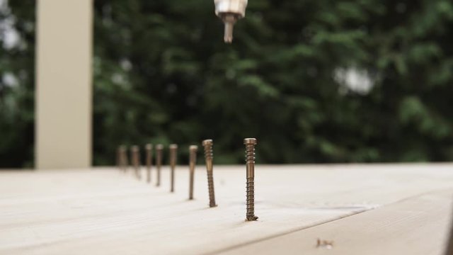 screwing the screw into the terrace boards