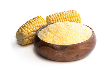 Corn maize meal in wooden bowl isolated on white