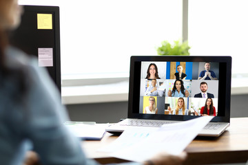 Woman talking with international colleagues using online video chat service