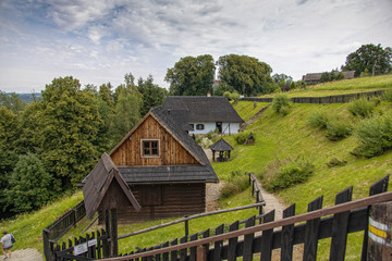 Fototapeta na wymiar historic wooden rural buildings with an open-air museum in Dobczyce Polish mountains on a summer day