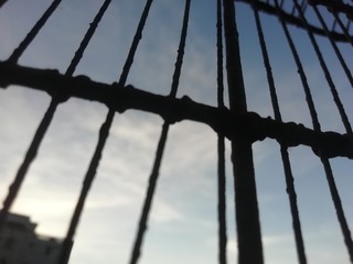 Cage view of sky at evening time