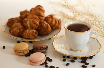 a cup of coffee and small cakes are served on the table