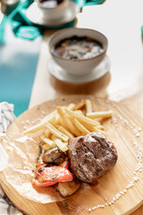 photos of dishes grilled meat French fries in cafes bright Sunny natural light