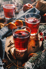 Festive mulled wine with lingonberry on a wooden table. Glasses of mulled wine.