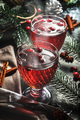 Festive mulled wine with lingonberry on a wooden table. Glasses of mulled wine.
