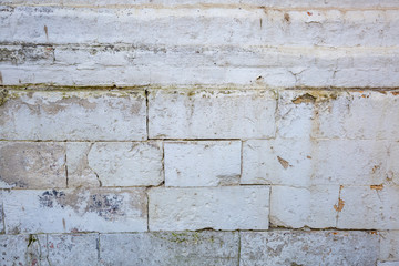 Embossed textured surface of an old wall made of facade bricks and cement