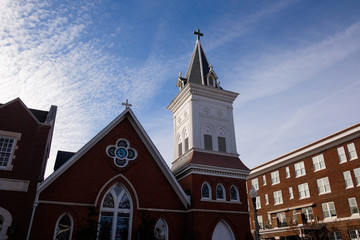 Fototapeta na wymiar Southern Baptist church steeple with clouds and blue sky