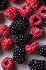 Tasty fresh ripe raspberry and blackberry berries, healthy food texture, top view macro