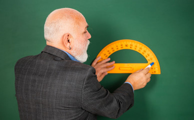 no mistakes. Education and school concept. home learning. senior man teacher use protractor tool....