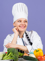 Eat your greens. Professional chef with many healthy products. Happy chef preparing meal with various vegetables. ready to cook new dish. Fresh vegetarian salad. Chef cook in commercial kitchen