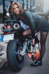 Fototapeta na wymiar A custom motorcycle and a girl in jacket. Sport hobby. Nopeople streets and single girl with her urban bike.