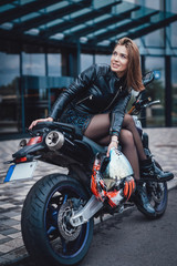 Naklejka na ściany i meble Motosport hobby. Urban custom motorcycle and his female beauty owner. Sunny streets of city.