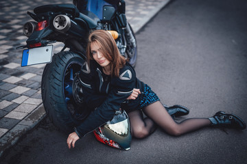 Plakat Young cute female driver and dark modern bike. Urban powerfyl vehicle. Motosport hobby.