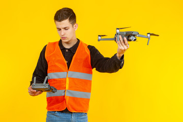 Quad copter. Man with a drone in his hands. Guy is holding a drone camera with outstretched hand....