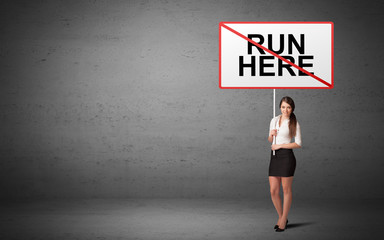 business person holding a traffic sign with RUN HERE inscription, new idea concept