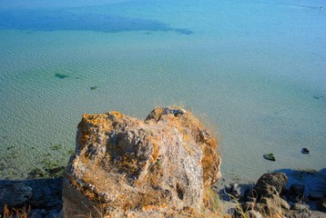
Stone by the blue sea on the beach