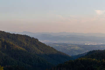 Panorama at sunset from the mountains of the Black Forest near Gersbach over the Wehratal and the city of Wehr towards the Swiss Alps