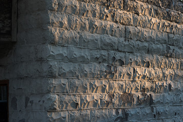 Textured Stone Wall at Sunset Background
