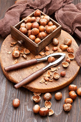Hazelnut with nutcracker on  wooden board