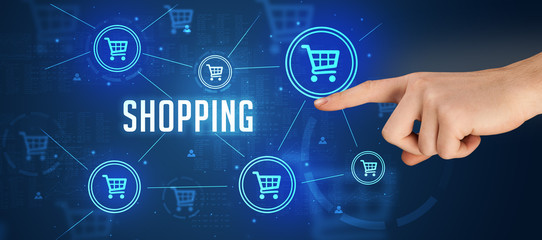 Close-Up of cropped hand pointing at SHOPPING inscription, online shopping concept