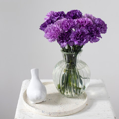 Bridal bouquets of lilac carnations in a four round glass vases different sizes as table decoration