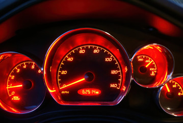 The glowing red speedometer of a Pontiac G6 with emblems removed.