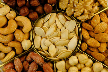 Healthy nuts, almonds, walnut, cashew, pumpkin seed and peanut background texture. Roasted and fresh raw organic mixed snacks.