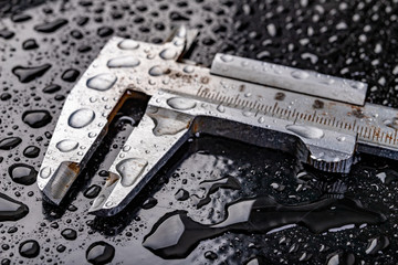 Metal measuring devices covered with water. Wet measuring tools.
