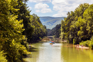  People sail on catamarans on a mountain river on a sunny summer day. View from above. Water...