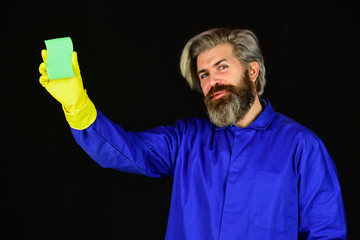 Disinfection concept. Bearded cleaner in blue uniform. Spring cleaning. Hipster clean house. Virus...