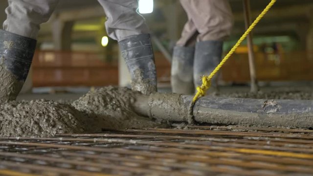 Pouring concrete mix on concreting formwork. Forming, an essential part of the entire building process. Before concrete can be poured, forms need to be built to hold the concrete in place
