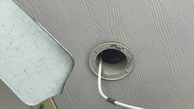 Rotating brush on drill cleaning lint buildup in dryer vent pipe