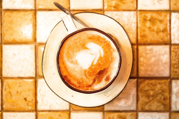 a cup of cappuccino coffee on the table