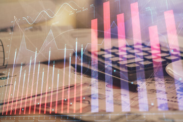 Double exposure of financial chart drawings and desk with open notebook background. Concept of forex market