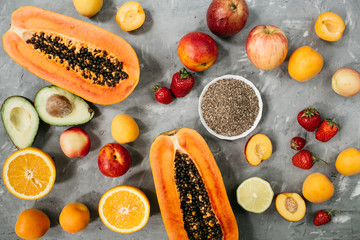 Healthy food clean eating selection: fruit, berries, Chia seeds, superfood on gray concrete background.Top view, flat lay.