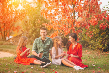 Portrait of happy family of four in autumn day