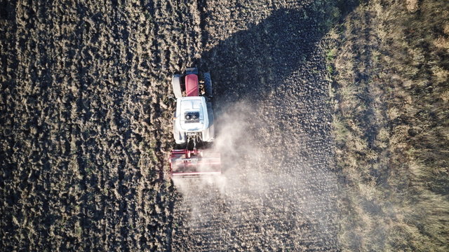 Farmer plowing his field. It plows and aerates the soil with a tractor.