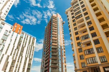 modern architecture of big city landmark view foreshortening from below perspective urban photography in clear weather bright colors day time sky background