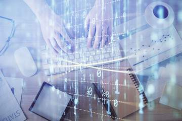 Double exposure of man's hands typing over computer keyboard and data theme hologram drawing. Top view. Technology concept.