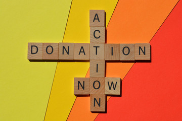 Action, donation, now, words in wooden alphabet letters in crossword form