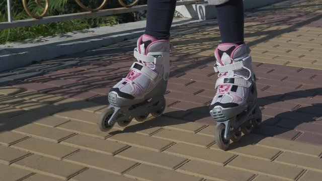 Steps on roller skates. Children's feet are rolling in roller skates.