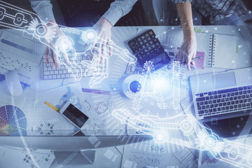 Double exposure of man and woman working together and data theme hologram drawing. Computer background. Top View.