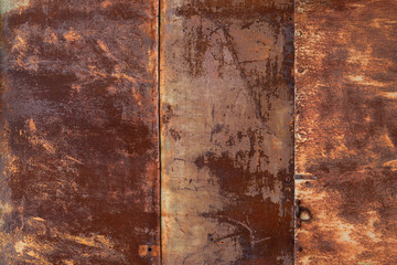 Full-screen texture of rusty metal sheets wall